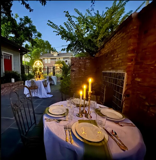 An intimate candlelit table in the Dickason Cottage courtyard